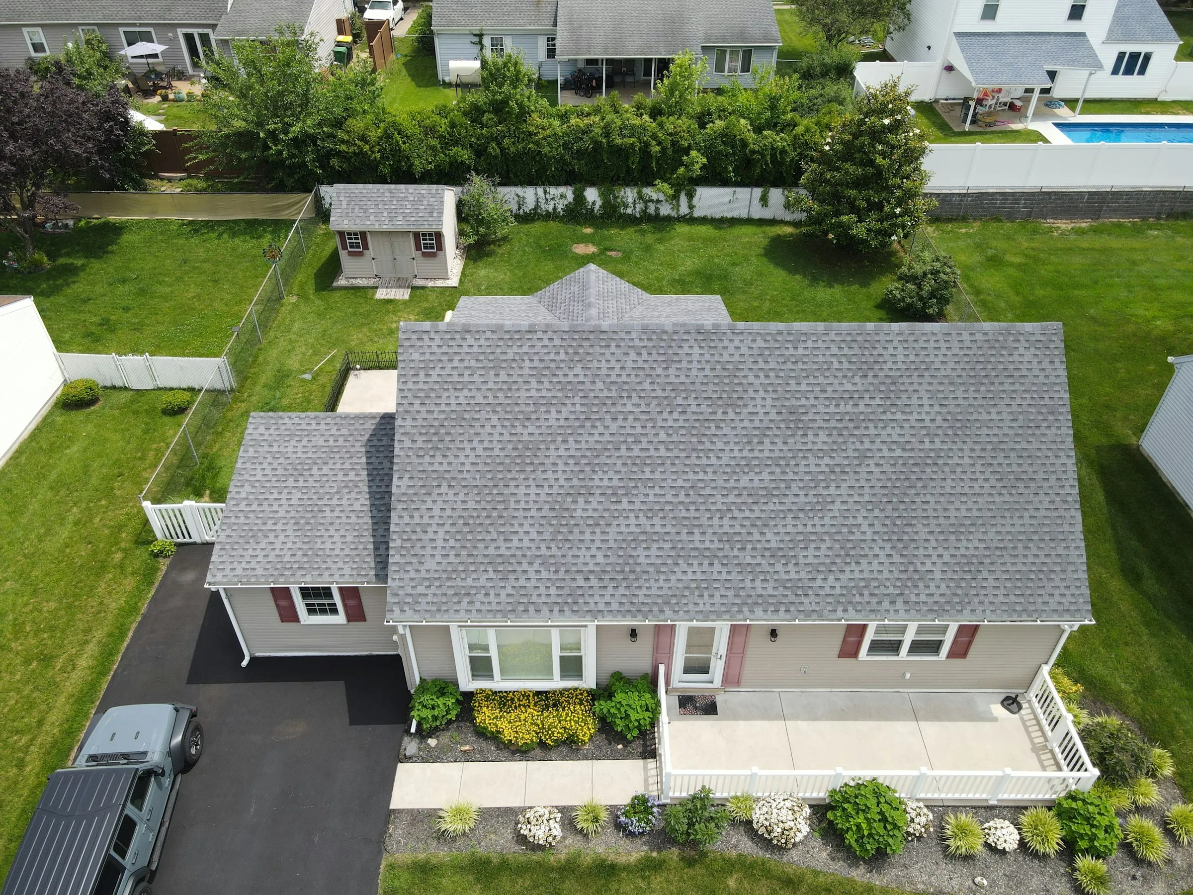Aerial view of a home with a grey shingle roof