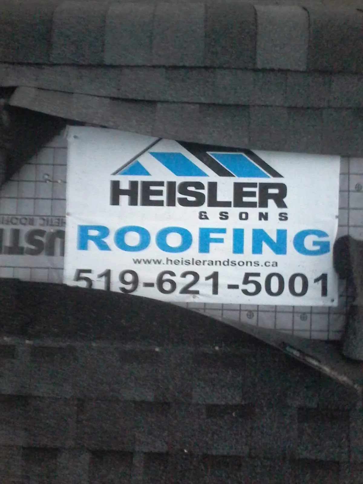 Heisler & Sons Roofing sign on a job site